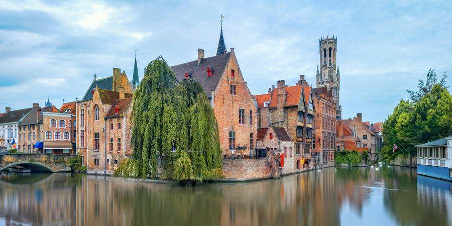 View from the Rozenhoedkaai in Brugge with the Perez de Malvenda house and Belfort van Brugge in the background in morning light