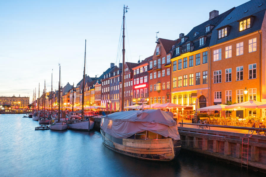 a city view of Nyhavn at night in Denmark.