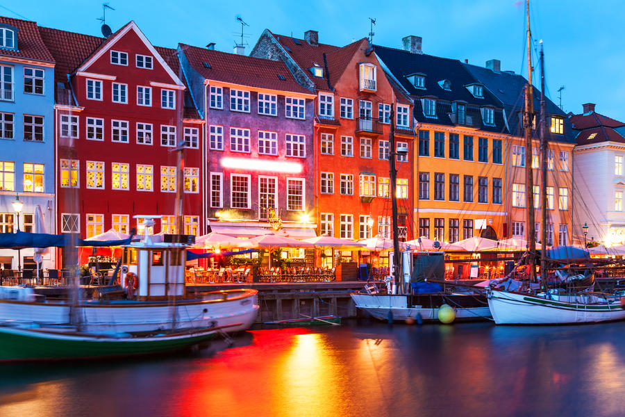 Scenic evening panorama of famous Nyhavn pier architecture in the Old Town of Copenhagen, Denmark