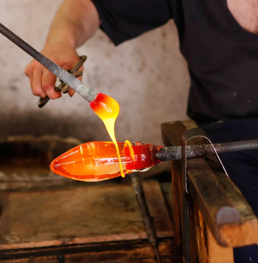 Glass blower forming a decorative vase. (Murano, Italy)