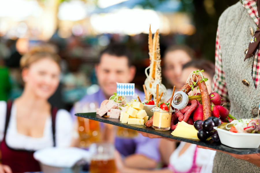 In Beer garden in Bavaria, Germany - beer and snacks are served; focus on meal