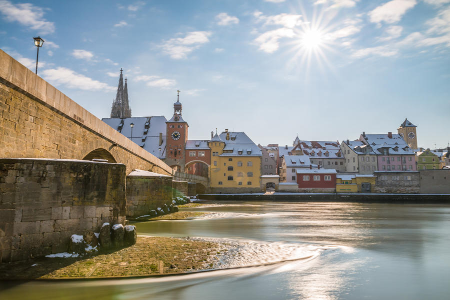 Regensburg at winter with the promenade the Cathedral and the stone bridge, Germany