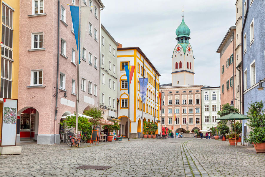 Colorful buildings in the center of Rosenheim and tower of Sankt Nikolaus Church, Germany