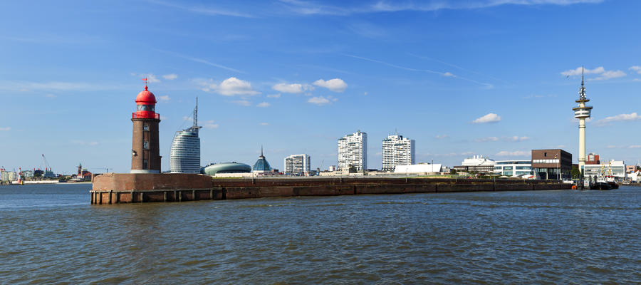 Panoramic view of Bremerhaven with historic lighthouse on the pier in foreground