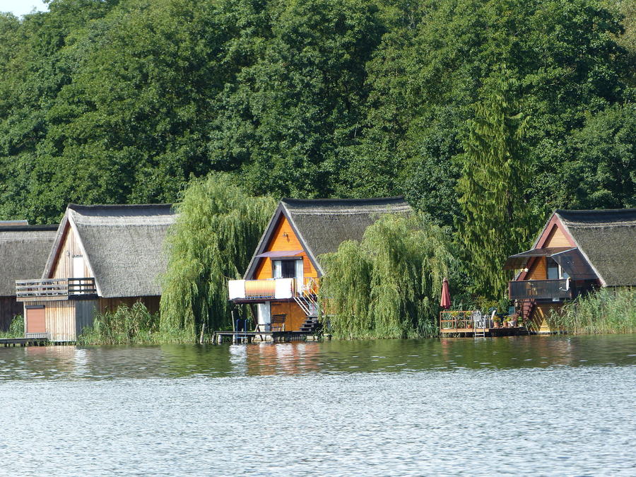 Boat houses in the Müritzarm near Priborn. Müritzarm is a lake in the Mecklenburgische Seenplatte district in Mecklenburg-Vorpommern, Germany