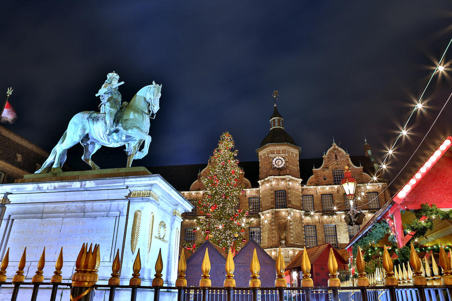 Dusseldorf Christmas Market and historic city hall. Dusseldorf's Christmas Market turns the city into a winter's fairy tale with seasonally decorated huts and magic atmosphere.