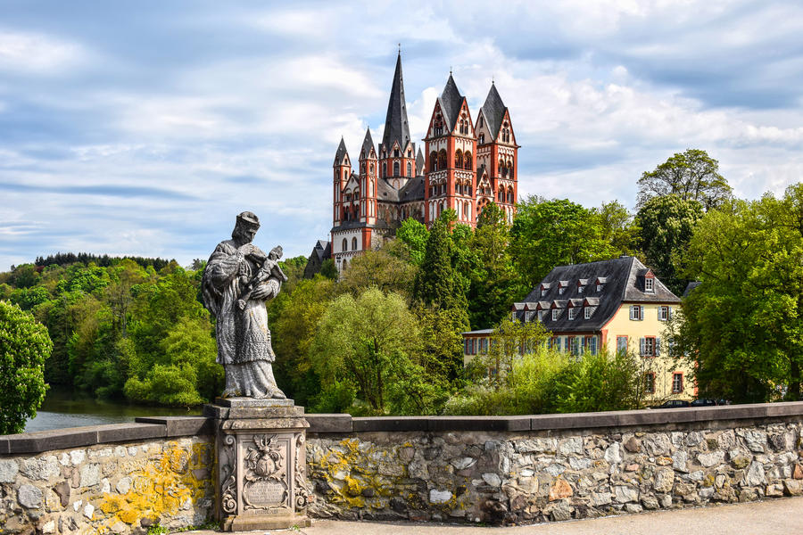 The Catholic Cathedral of Limburg at the river Lahn (German: Dom zu Limburg), Germany, viewed from the old Lahn bridge with a statue of Saint John of Nepomuk.