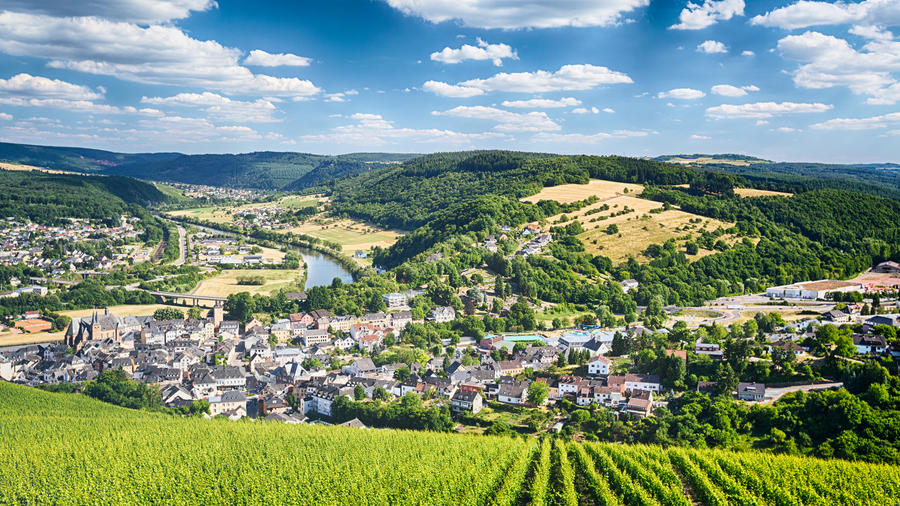 Summer scenery of the town of Saarburg, Germany surrounded by mountains and vineyards.
