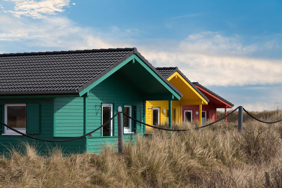 Helgoland city - colorful wooden tiny houses on the island Dune near island Helgoland against blue sky