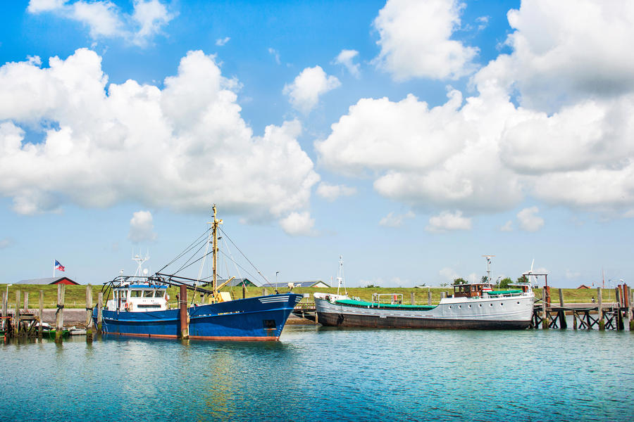 Traditional fishing boats lying in harbor at North Sea in Nordfriesland, Schleswig-Holstein, Germany