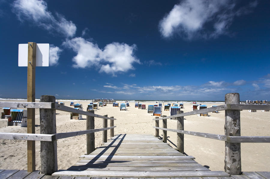 a lot of beach chairs at the beach of Sankt Peter Ording,  North Sea, blue sky in summer