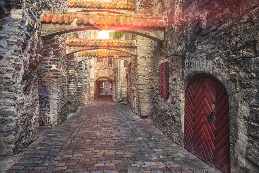 St. Catherine's Passage in Tallinn, Estonia. A sunlight through the window shining at the little walkway in the old city. Lens flares