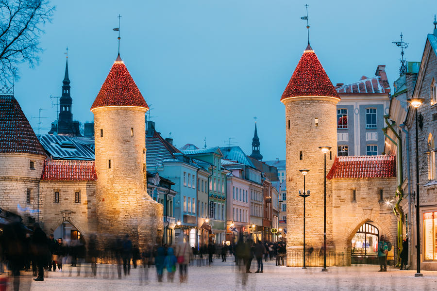 Tallinn, Estonia. Famous Landmark Viru Gate In Street Lighting At Evening Or Night Illumination. Christmas, Xmas, New Year Holiday Vacation In Old Town. Popular Touristic Place