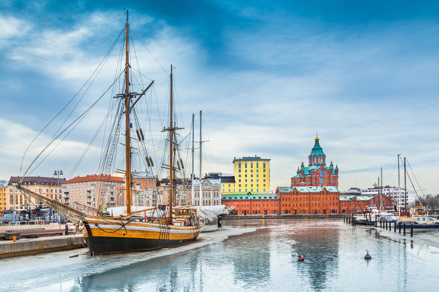Beautiful view of Helsinki city center with famous Uspenski eastern orthodox cathedral church and old port in Katajanokka district of Helsinki on a cold winter day with blue sky and clouds, Finland