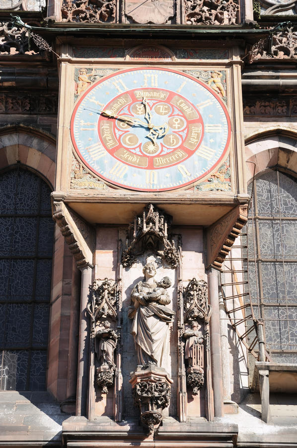 Medieval clock on pink stone cathedral of Strasbourg, France