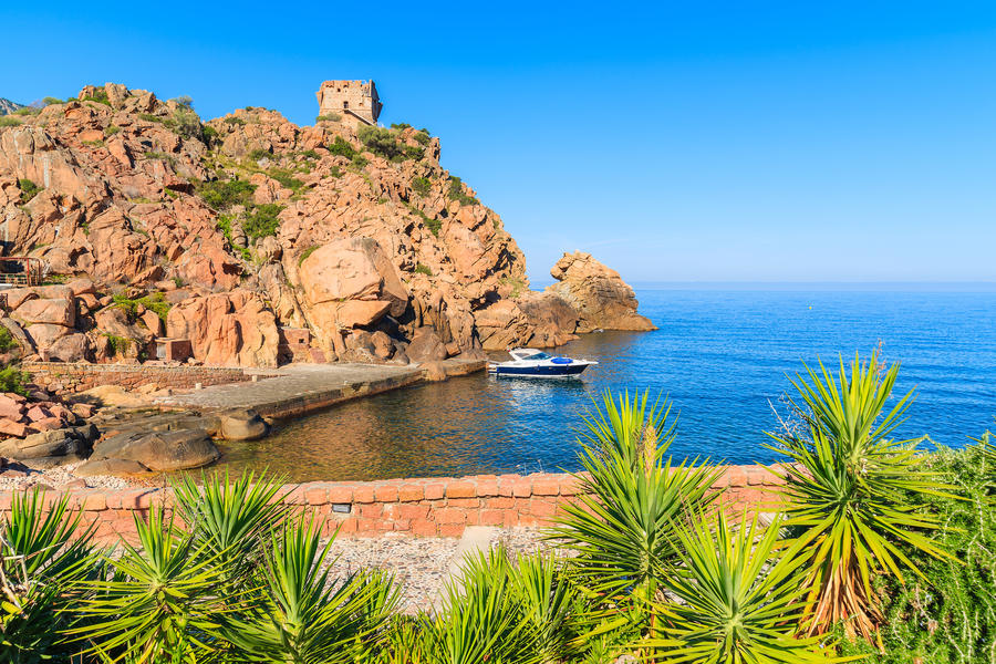 View of bay with boat on blue sea in Porto town, Corsica island, France
