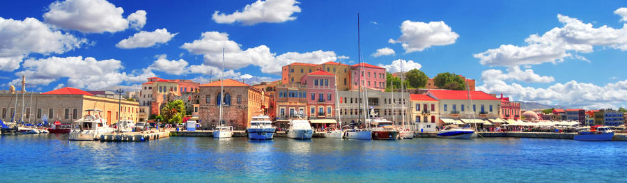 Colorful panoramic HDR image of the beautiful old Venetian Harbour of the city of Chania with boats and yachts on cloudy blue sky and turquoise water, Crete, Greece