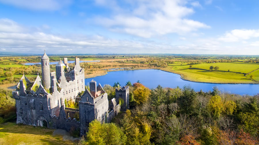 An aerial view of Dromore Castle, Limerick, Ireland. Dromore Castle is a very distinctive building sitting high on a hill overlooking two lakes in Co. Limerick.