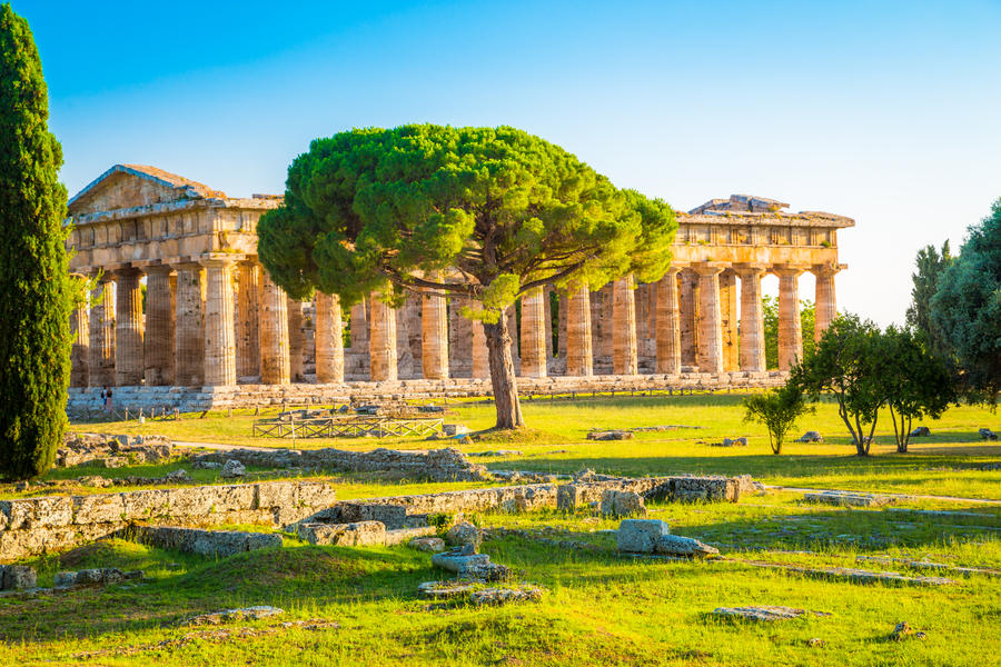 Beautiful view of famous Paestum Temples Archaeological UNESCO World Heritage Sitein in scenic golden evening light at sunset, Province of Salerno, Campania, Italy