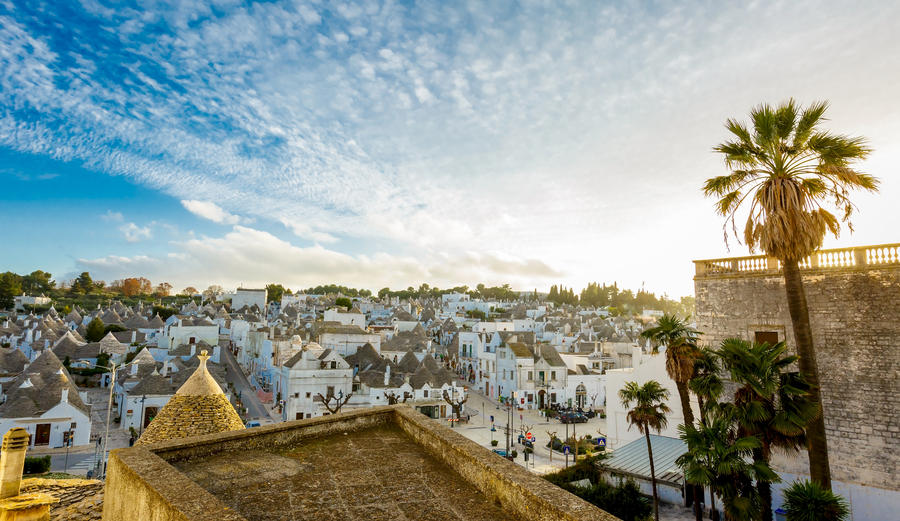 Cityscape of Alberobello; the trulli UNESCO world heritage town with unique stone walls, coned roofs, whitewashed housed during sunset evening, Puglia, Italy
