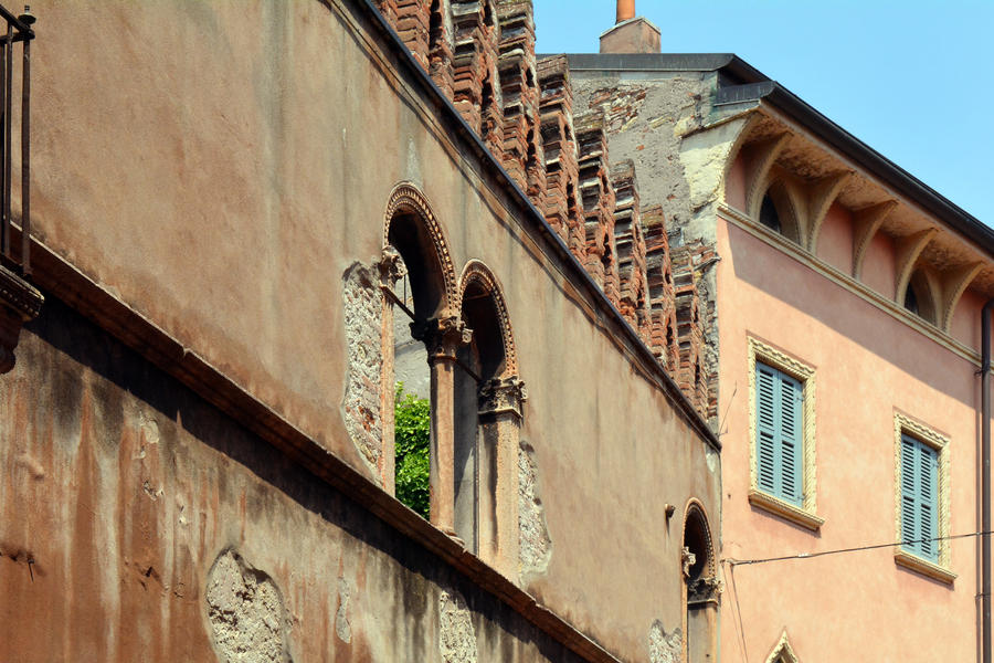 Old Italian buildings with red brick wall and arches on columns
