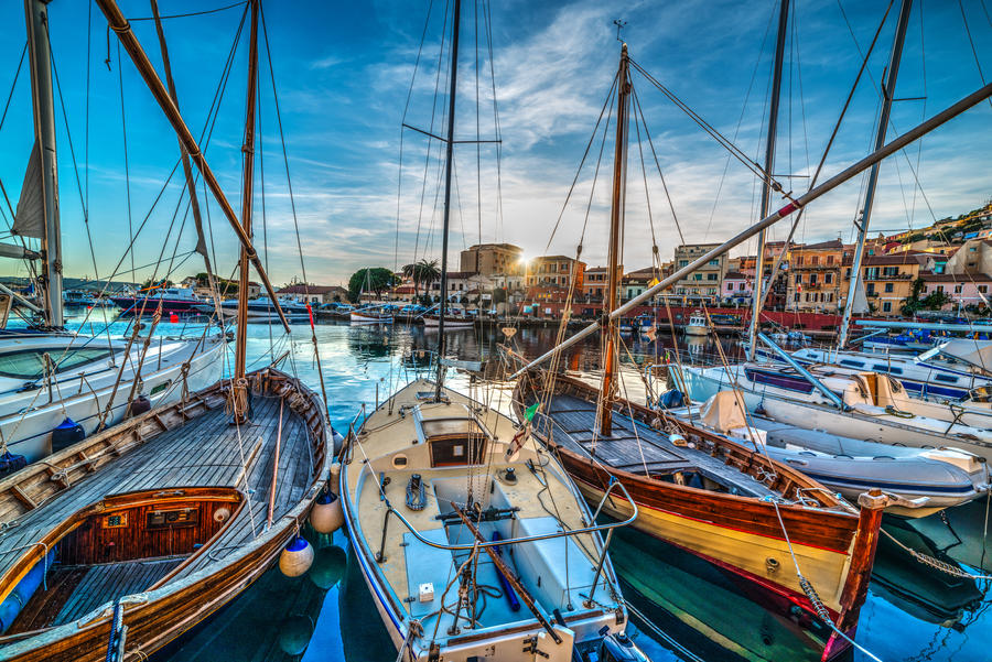 Wooden boats in La Maddalena harbor at sunset. Sardinia, Italy