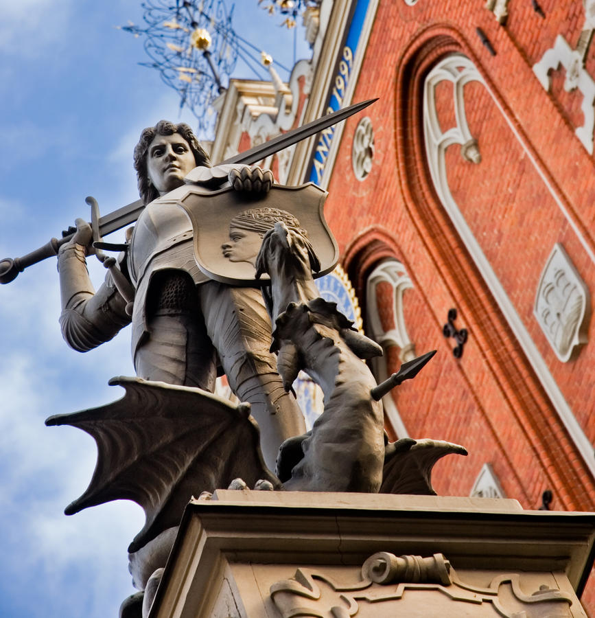 a statue of roland defeating a dragon on the house of blackheads in riga