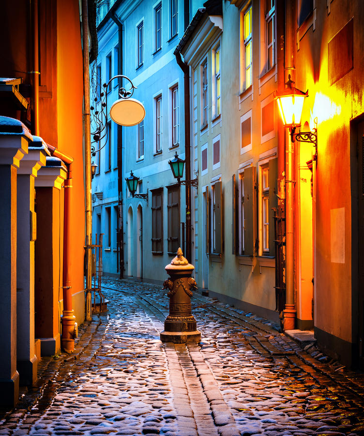 Narrow medieval street in old Riga city by winter at the early morning