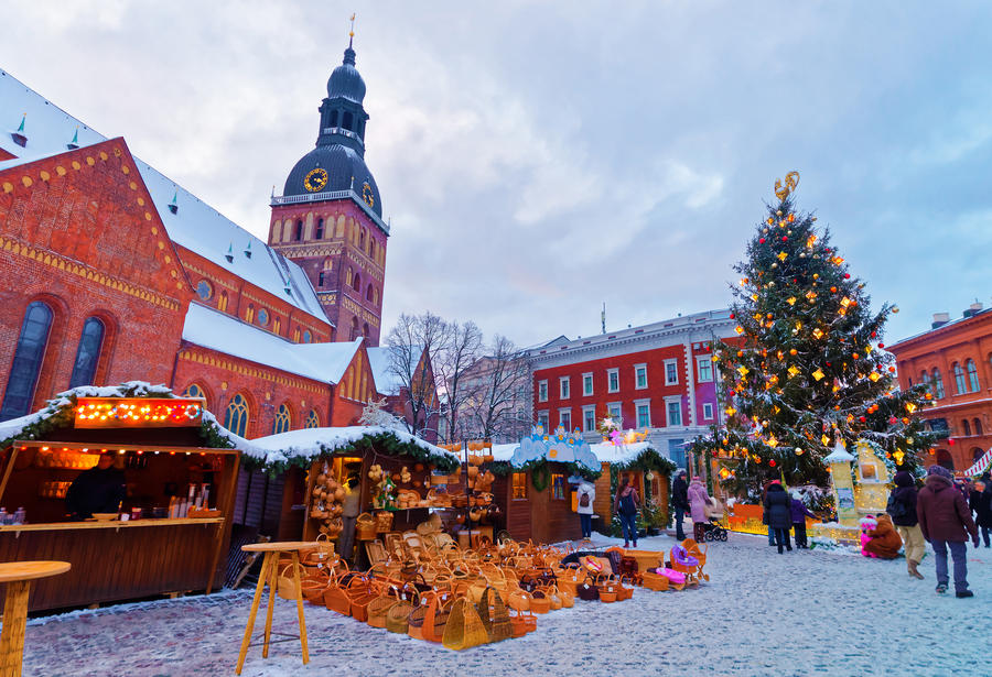 Beautiful snowy winter scenery of Christmas holiday fair at Dome Square in Riga's Old Town, Latvia