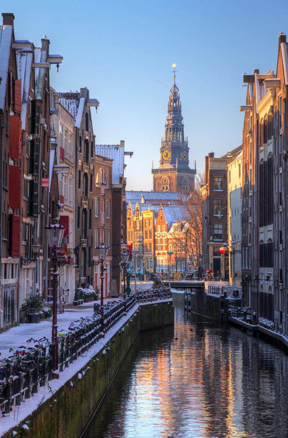 Winter cityscape of the Oudezijds kolk in Amsterdam, the Netherlands, with the Oude Kerk (old church, 1213) in the background. HDR