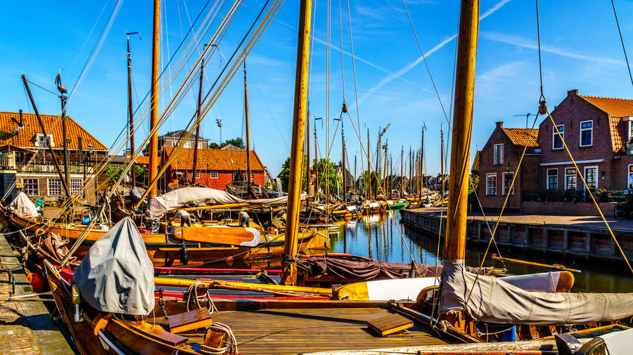 Traditional Dutch Botter Fishing Boats in the small Harbor of the Historic Fishing Village of Spakenburg-Bunschoten in the Netherlands. The village was at one time a harbor on the inland sea IJselmeer