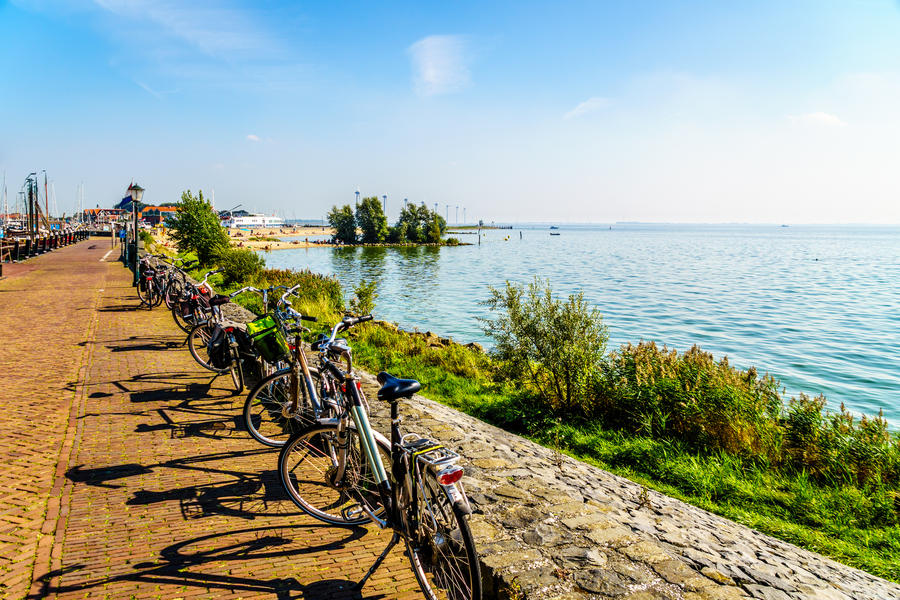 Typical Dutch Bikes parked at the promenade along the inland sea named IJselmeer seen from the historic fishing village of Urk in the Netherlands