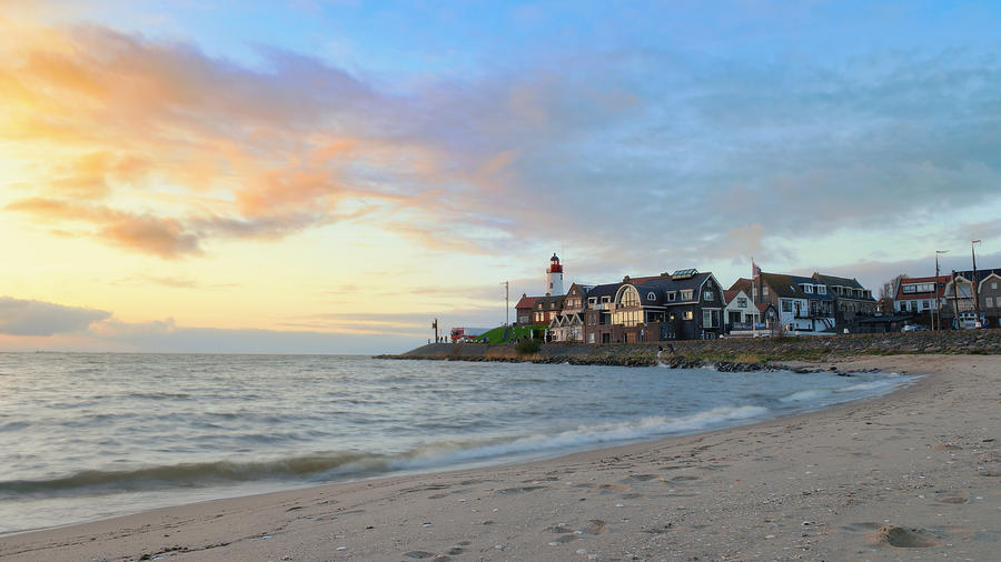 Sunset sky by the lighthouse of urk on the rocky beach at the lake Ijsselmeer by the former island Urk Flevoland Netherlands