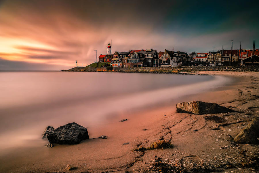 Sunset sky by the lighthouse of urk on the rocky beach at the lake Ijsselmeer by the former island Urk Flevoland Netherlands