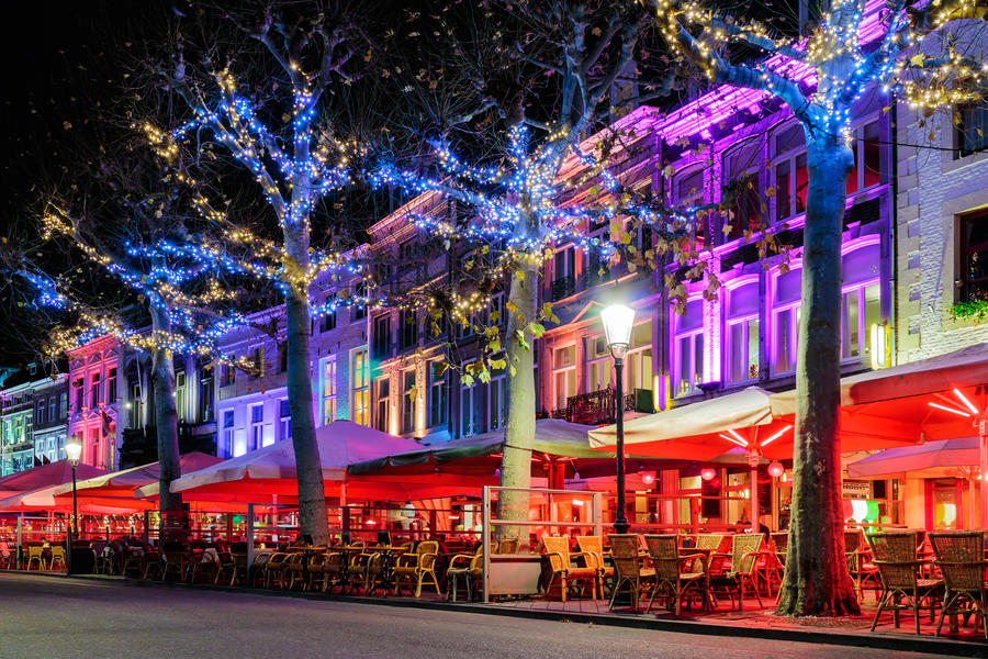 Bars and restaurants with christmas lights on the famous Vrijthof square in Maastricht, The Netherlands