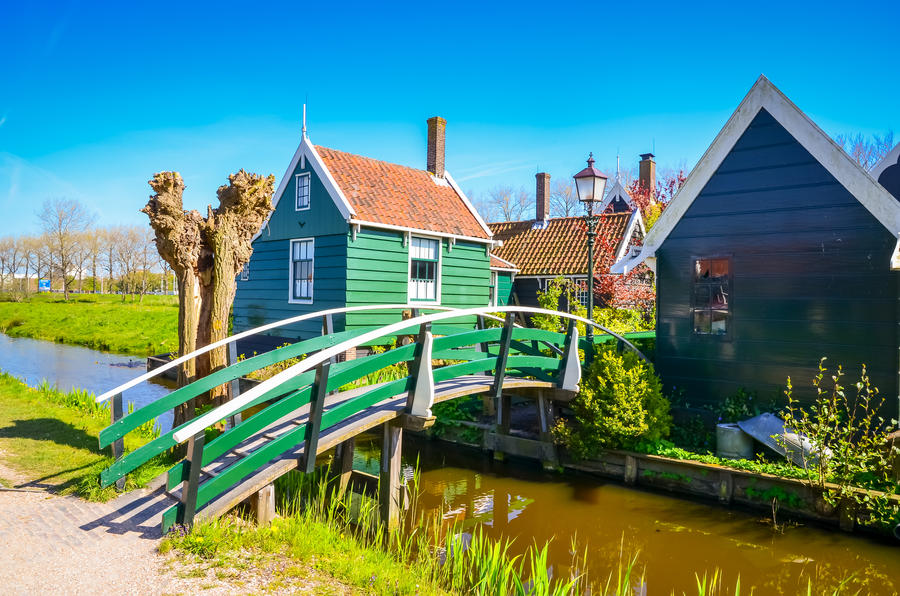 Traditional dutch windmills and houses near the canal in Zaanse Schans, Netherlands, Europe