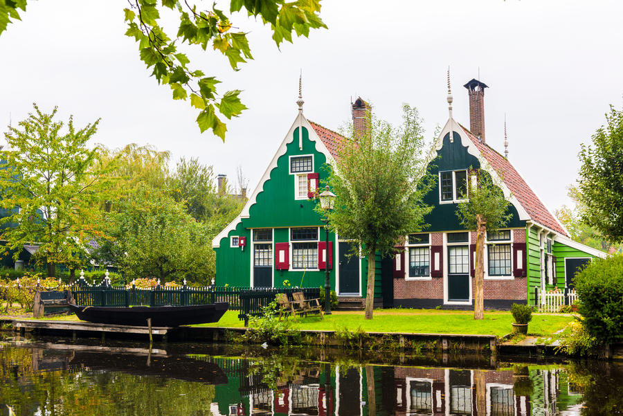 Traditional Dutch houses and windmills in Zaanse Schans. The Zaanse Schans is a typically Dutch small village in Amsterdam, Netherlands.