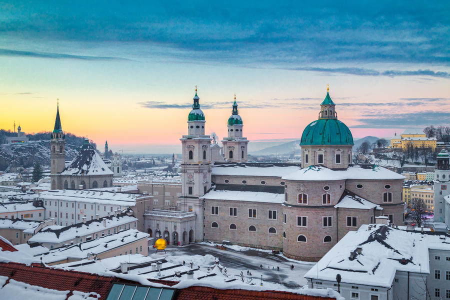 Classic panoramic view of the historic city of Salzburg with famous Salzburg Cathedral in beautiful evening light at sunset in winter, Salzburger Land, Austria