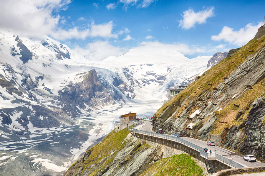 Dramatic view on the Grossglockner, seen from the Kaiser-Franz-Josefs-Höhe in the national wildpark in Tyrol, Austria. Partially snow covered mountains, shot against a partially clouded sky.