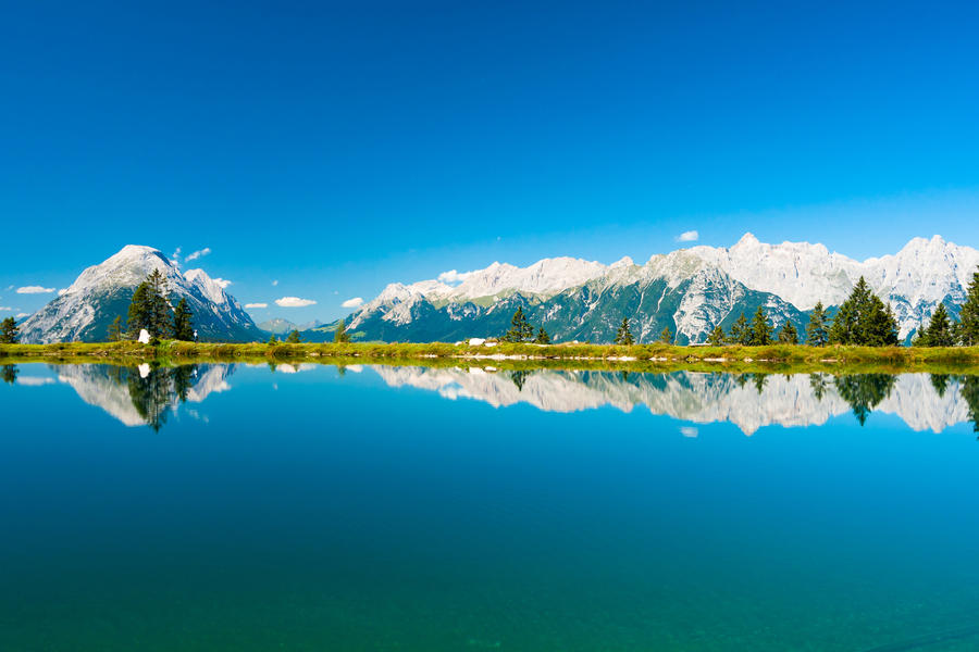 Perfect view on Kaltwassersee in Seefeld in Tirol and mountains reflecting in lake water