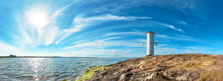 Panoramic image of a seaside by lighthouse in Swinoujscie, a port in Poland on the Baltic Sea.