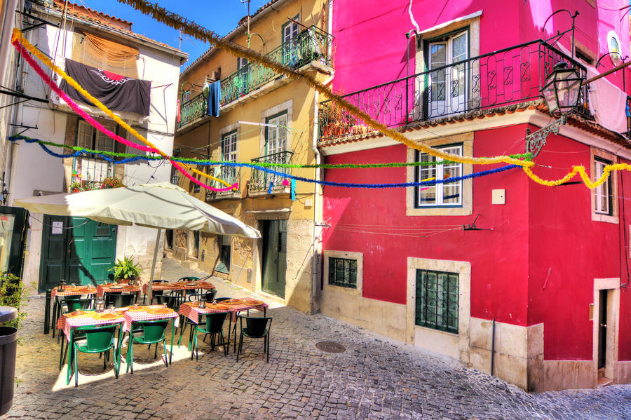 Beautiful wide angle image of the tight streets with lots of colors in Lisbon, Portugal. HDR