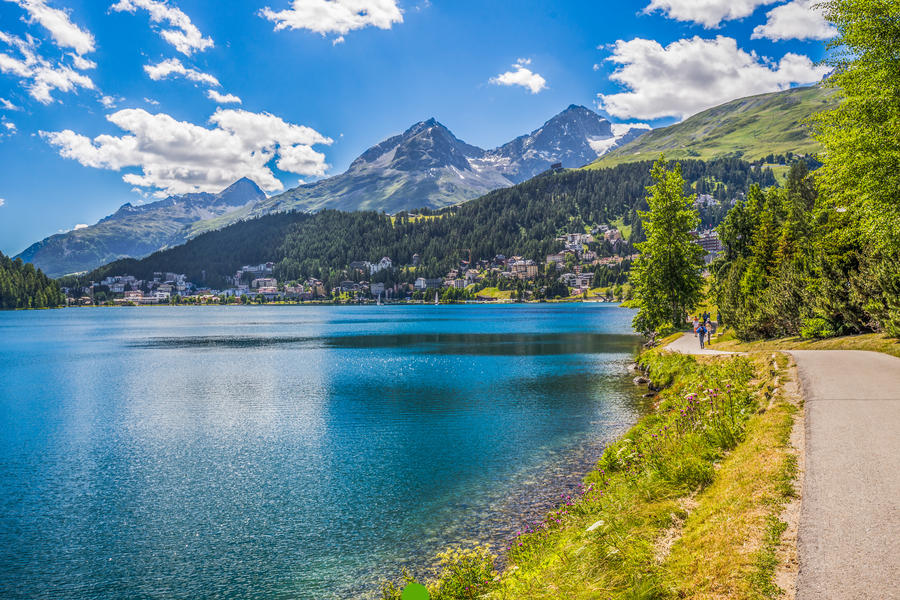 People walking along Sankt Moritzersee. St. Moritz (German - Sankt Moritz; Italian - San Maurizio) is a high Alpine resort in the Engadine, Graubunden, Switzerland.