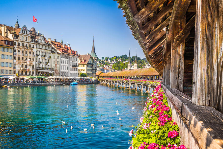 Famous Chapel Bridge in the historic city center of Lucerne, the city&#39;s symbol and one of Switzerland&#39;s main tourist attractions and views on a sunny day in summer, Canton of Lucerne, Switzerland