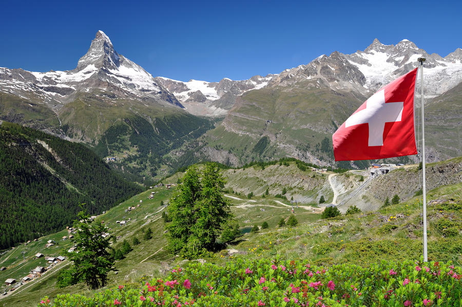 Beautiful mountain Matterhorn with Swiss flag - Swiss Alps