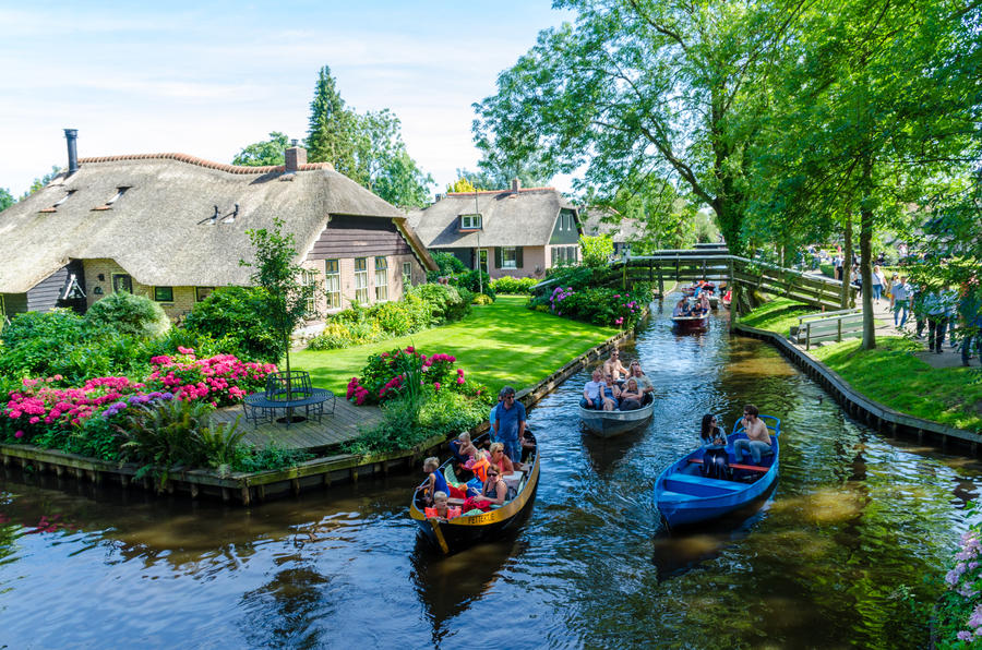 GIETHOORN, NETHERLANDS - JULY 17,2016: view of typical houses of Giethoorn on July 17, 2016 in Giethoorn,The Netherlands. The beautiful houses and gardening city is know as "Venice of the North".