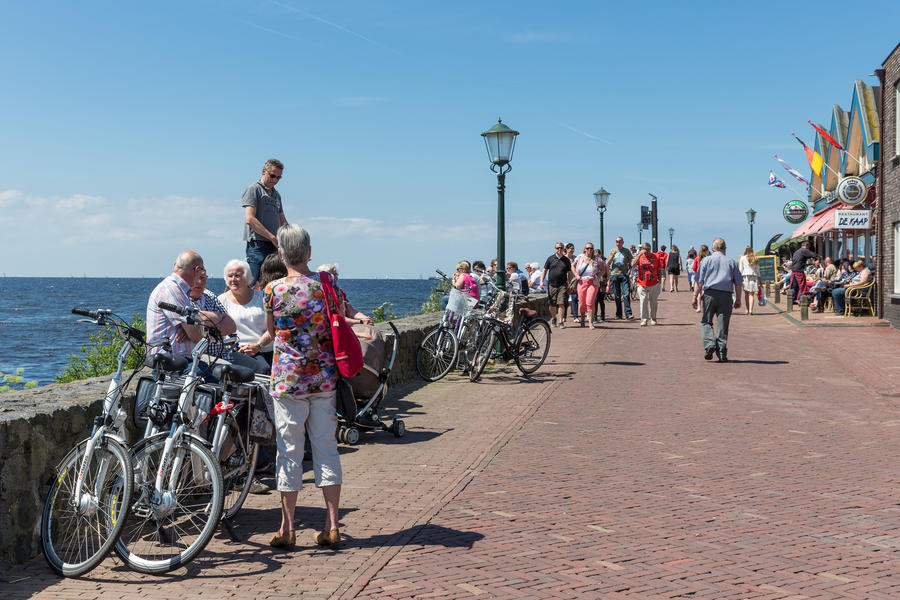 URK, THE NETHERLANDS - MAY 31: Tourists visiting the promenade along the sea during the local fishing days on May 31, 2014 at the harbor of Urk, the Netherlands