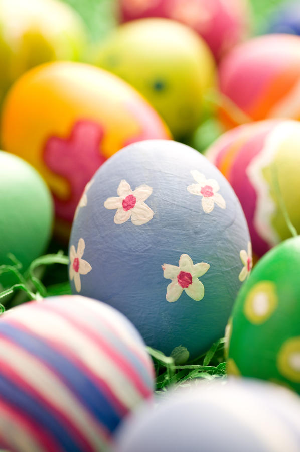 Cheerful cluster of easter eggs painted with rough strokes - close up
