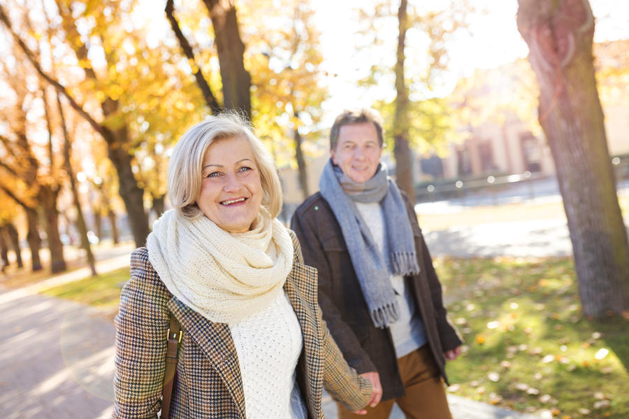 Active seniors on a walk in autumn town