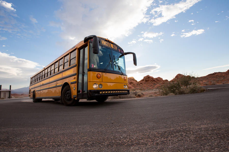 Yellow school bus on the road in Grand Canyon, USA
